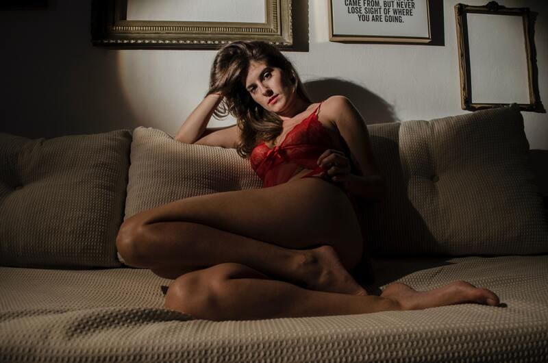 Femme en tenue sexy dans son canapé